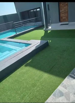 a house with a swimming pool and green grass at Giyani Shamba Lodge in Giyani