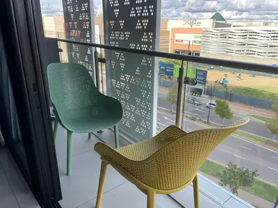 two chairs sitting in front of a window at Entire Apartment in Waterfall, South Africa in Midrand