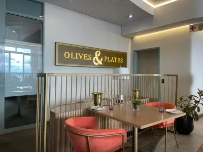 a restaurant with a wooden table and red chairs at Entire Apartment in Waterfall, South Africa in Midrand
