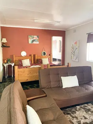 a living room with a couch and a bed at Havana Nights in Graskop