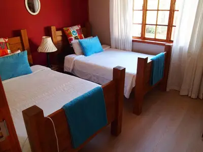 a bedroom with two beds and a window at Havana Nights in Graskop