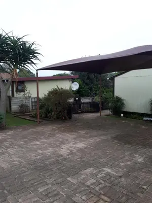 a patio with awning in front of a house at Havana Nights in Graskop
