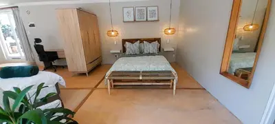 a small bedroom with a bed and a mirror at Joy Haven - Open Plan Studio in Centurion