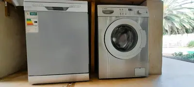 a washing machine next to a washer and a window at Joy Haven - Open Plan Studio in Centurion