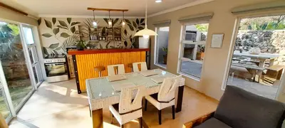 a dining room with a table and some chairs at Joy Haven - Open Plan Studio in Centurion
