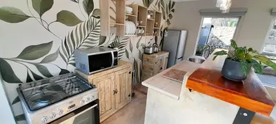 a kitchen with a sink and a stove top oven at Joy Haven - Open Plan Studio in Centurion