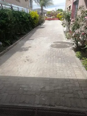 a cobblestone street with a man hole in the middle at Walalawasala in Polokwane
