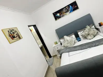 a small bedroom with two beds and a mirror at Chilled Vibe Lodge in Soshanguve