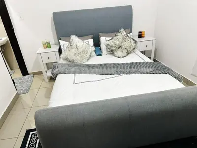 a large bed with two pillows on top of it at Chilled Vibe Lodge in Soshanguve