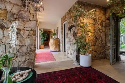 a hallway of a house with a stone wall at Glenferness AH Villa in Midrand