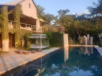 a house with a swimming pool in front of a house at Glenferness AH Villa in Midrand