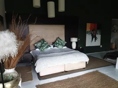 a bedroom with a bed with green pillows on it at Glenferness AH Villa in Midrand
