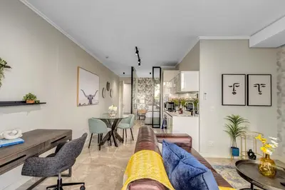 a living room with a couch and a table at Mvilo, Luxury Apartment, Ellipse Waterfall in Midrand