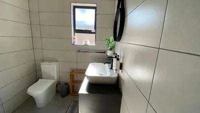 a small bathroom with a toilet and a sink at Ikigai@4617 Cottage in Marloth Park