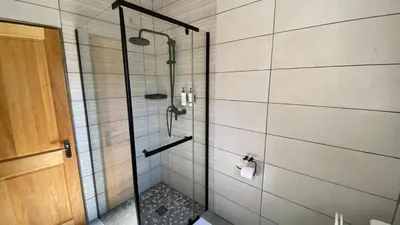 a shower with a glass door in a bathroom at Ikigai@4617 Cottage in Marloth Park