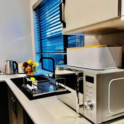 a kitchen with a sink and a microwave at Ikigai@4617 Cottage in Marloth Park