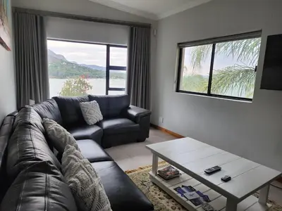 a living room with a couch and a coffee table at BondMakers at Kosmos in Hartbeespoort