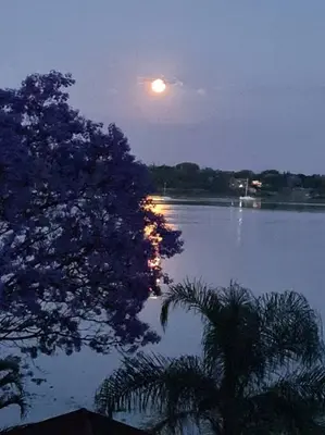a moon rising over a body of water at night at BondMakers at Kosmos in Hartbeespoort