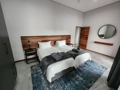 a bedroom with a large bed with a large mirror at Bald Ibis (856 Highland Gate) in Dullstroom