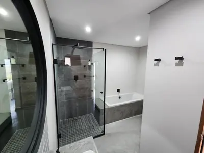 a bathroom with a shower and a bath tub at Bald Ibis (856 Highland Gate) in Dullstroom