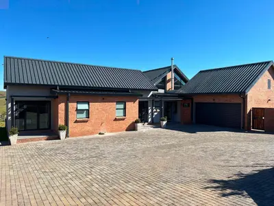 a brick house with a driveway in front of it at Bald Ibis (856 Highland Gate) in Dullstroom