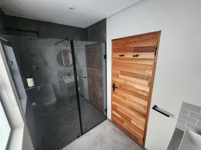 a shower with a glass door in a bathroom at Bald Ibis (856 Highland Gate) in Dullstroom