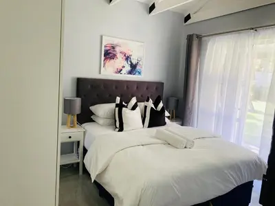a bedroom with two beds and a window at Cozy Guest Suite 2-with back up power in Midrand