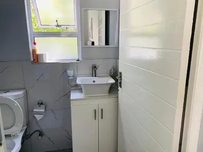 a small bathroom with a sink and a toilet at Cozy Guest Suite 2-with back up power in Midrand