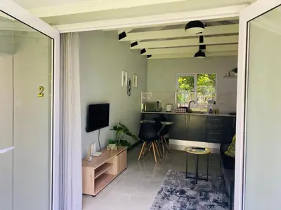 a room with a kitchen and a living room at Cozy Guest Suite 2-with back up power in Midrand
