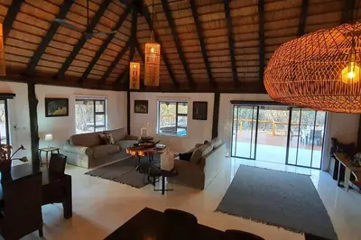 a living room with couches and tables in a room at Luxury GuesthouseCo Butterfly House in Marloth Park