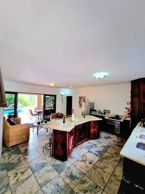 a kitchen with an island in the middle of a room at Luxury GuesthouseCo RiverDance in Marloth Park