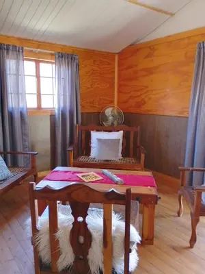 a room with a table and a bed in it at Faith Cabin in Waterval-Onder