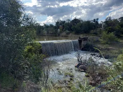 a waterfall in the middle of a river at Pumula Game Farm in Eersbewoond