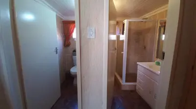 a bathroom with a toilet and a sink at Pumula Game Farm in Eersbewoond