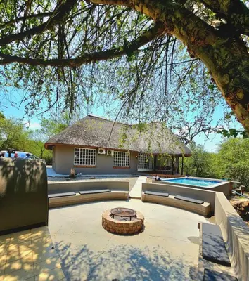 a house with a swimming pool in front of it at Luxury GuesthouseCo HiddenHouse in Marloth Park