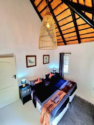 a bedroom with a large bed in a room at Luxury GuesthouseCo HiddenHouse in Marloth Park