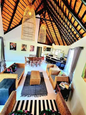a living room with couches and chairs and a table at Luxury GuesthouseCo HiddenHouse in Marloth Park
