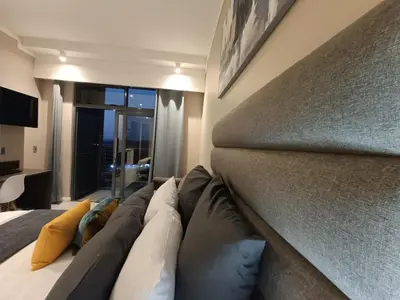 a bedroom with a large bed with pillows on it at Comfort at 1320 Menlyn Maine Residences in Pretoria