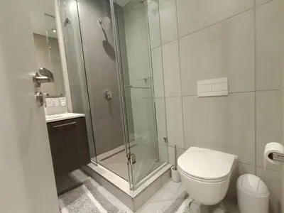 a bathroom with a glass shower and a toilet at Comfort at 1320 Menlyn Maine Residences in Pretoria