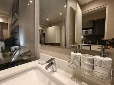 a bathroom with a sink and a mirror at Comfort at 1320 Menlyn Maine Residences in Pretoria
