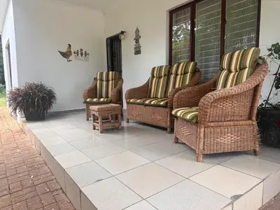 a group of chairs sitting on a porch at The Lake Villa in Benoni