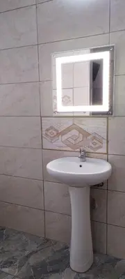 a bathroom with a white sink and a mirror at Whitehouse Lodge Benoni in Benoni
