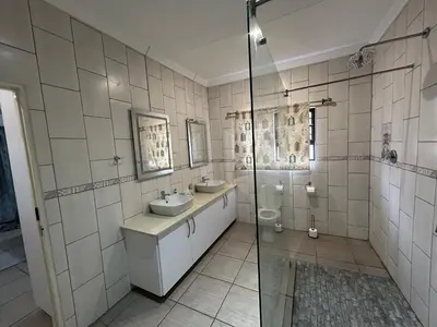a bathroom with two sinks and a shower at Melamar Estate in Marloth Park