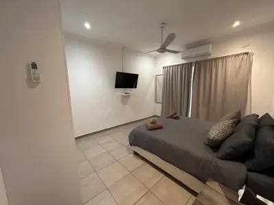 a bedroom with a bed and a flat screen tv at Melamar Estate in Marloth Park