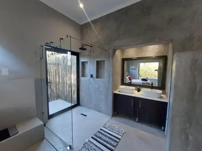 a bathroom with two sinks and a shower at House UmGanu in Marloth Park