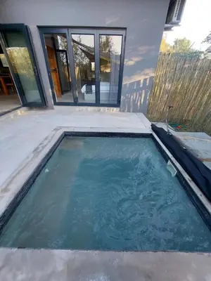 a swimming pool in front of a house at House UmGanu in Marloth Park
