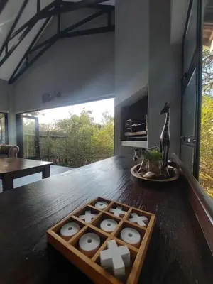 a room with a wooden table with a tray of treats at House UmGanu in Marloth Park