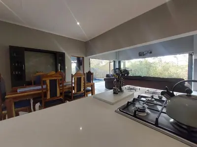 a kitchen with a stove and a counter top at House UmGanu in Marloth Park