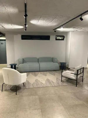 a living room with a couch and two chairs at Circa Lynnwood Studio in Pretoria