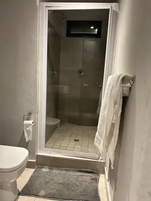 a bathroom with a shower with a toilet and a sink at Circa Lynnwood Studio in Pretoria